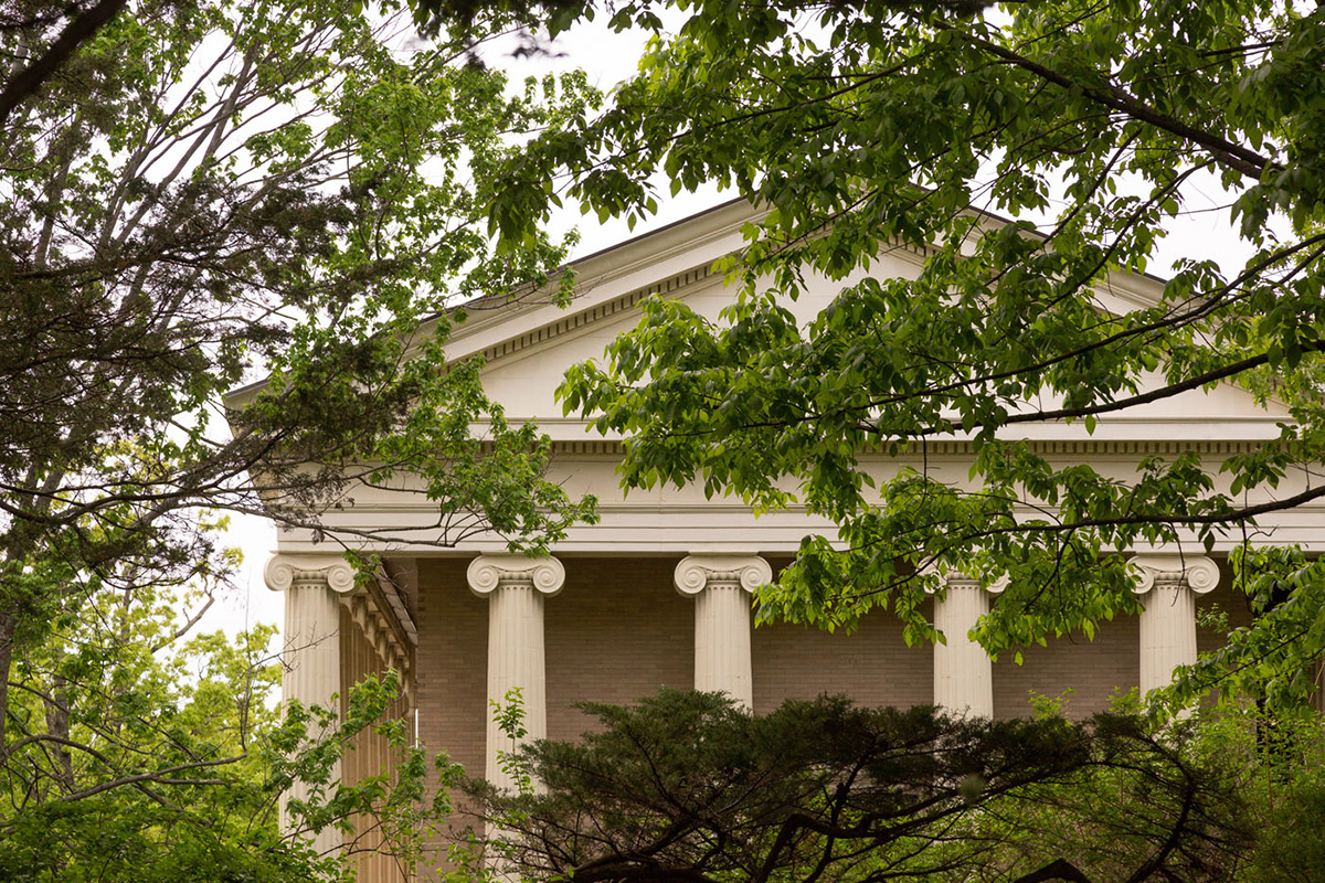 The exterior of the Stevenson Library at Bard College, green trees surrounding the facade of the building.