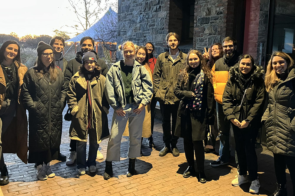 A class of warmly dressed Bard College students smiling and standing outside of stone building at Stone Barns Center.; Bard Professors Gabriel Perron and Swapan Jain Receive Research Grant from Stone Barns Center for Food and Agriculture