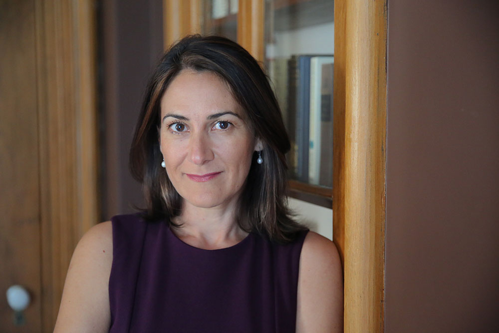 Pavlina R. Tcherneva sitting down while smiling at the camera.