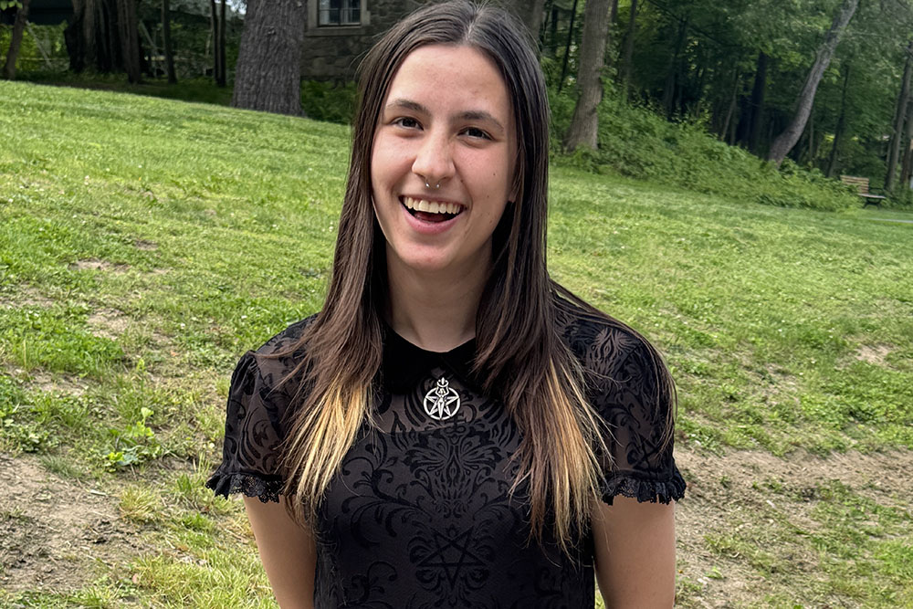 Close up of student smiling and wearing black.