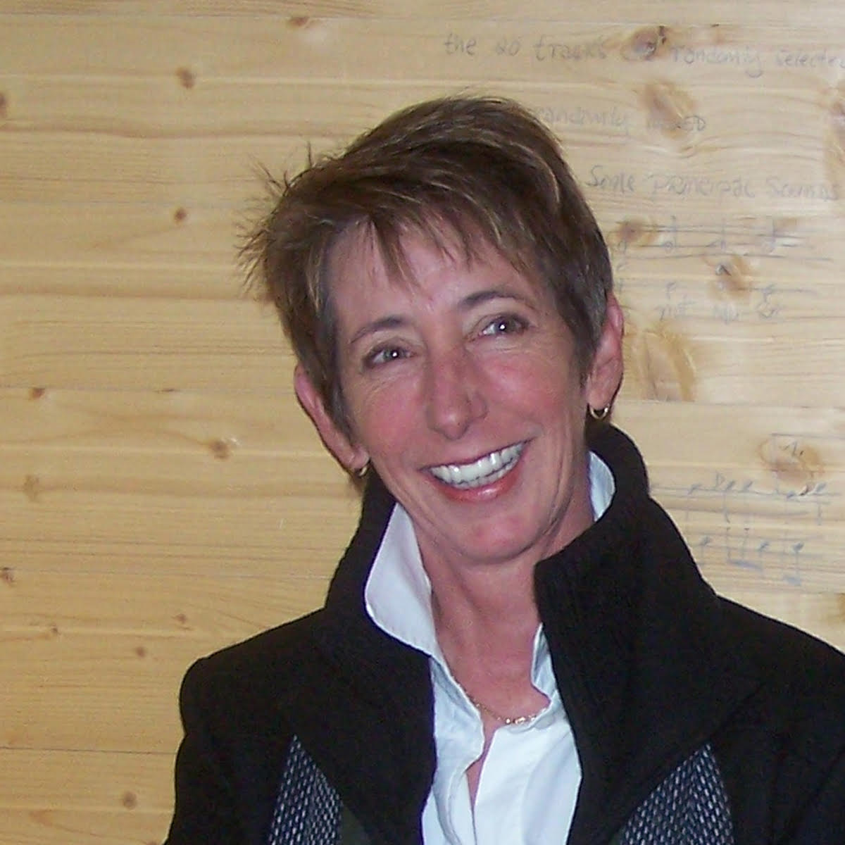 Professor Laura Kuhn smiles for the camera in a coat and scarf.