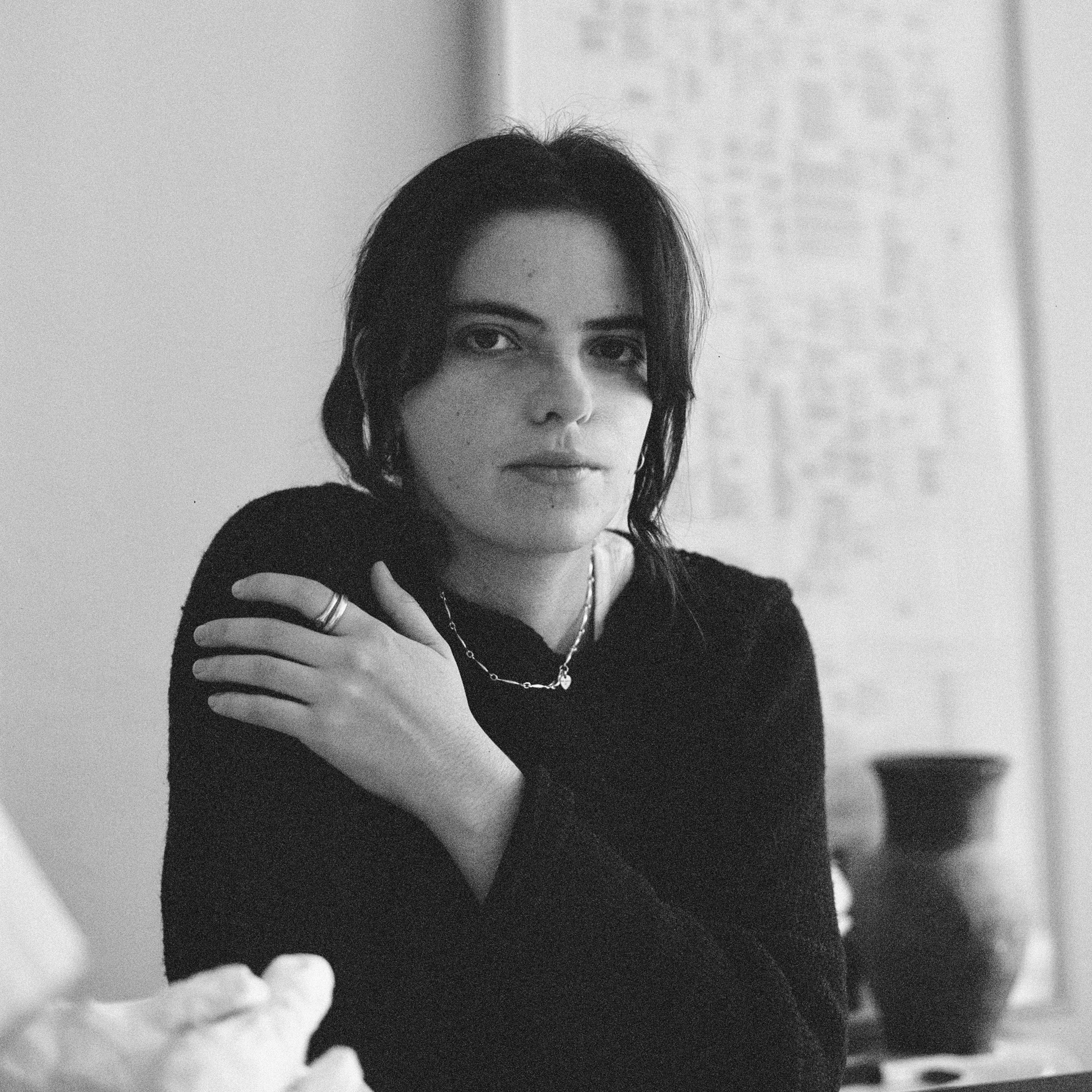 a black and white photo of a woman at a desk