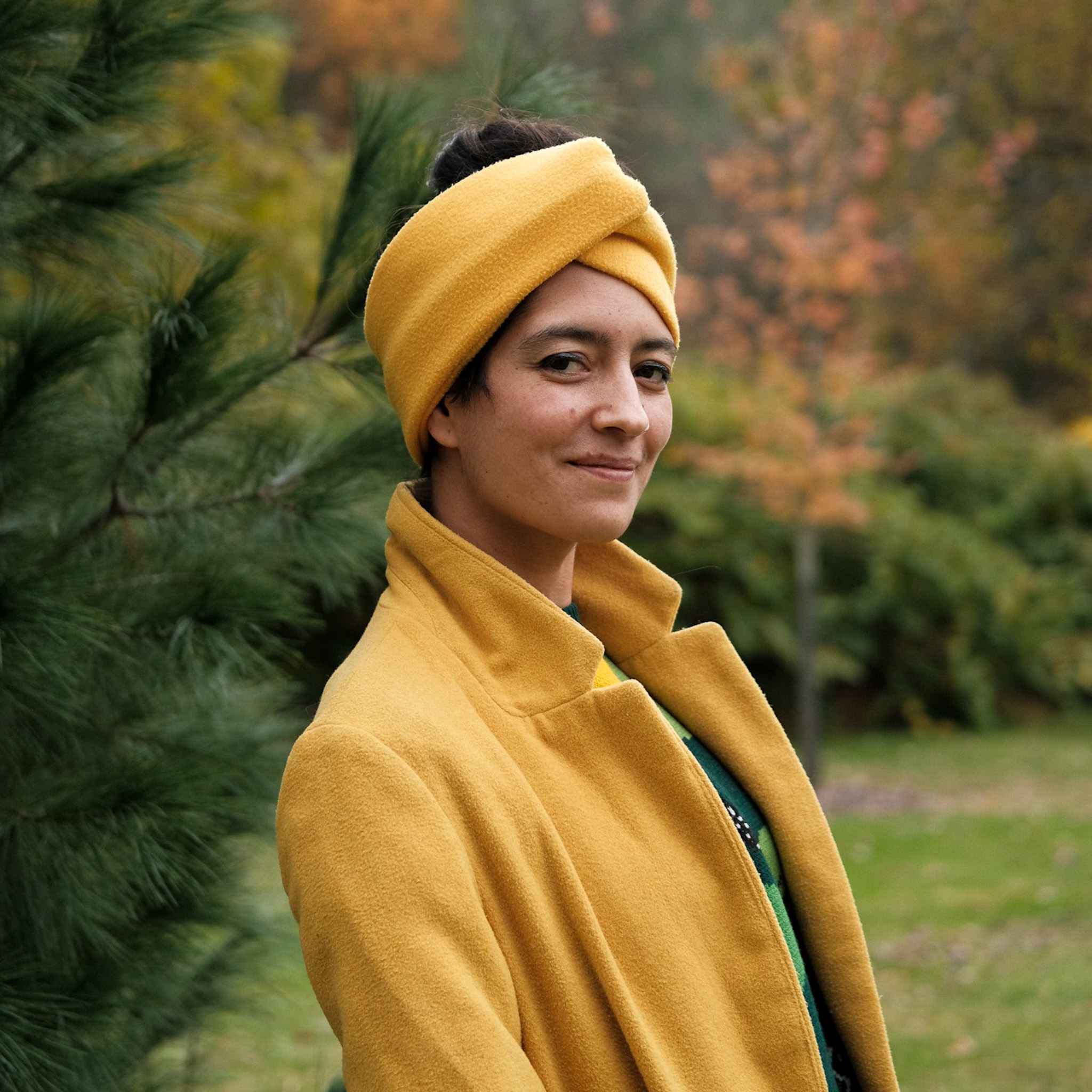 An image of Carol, dressed in warm yellow