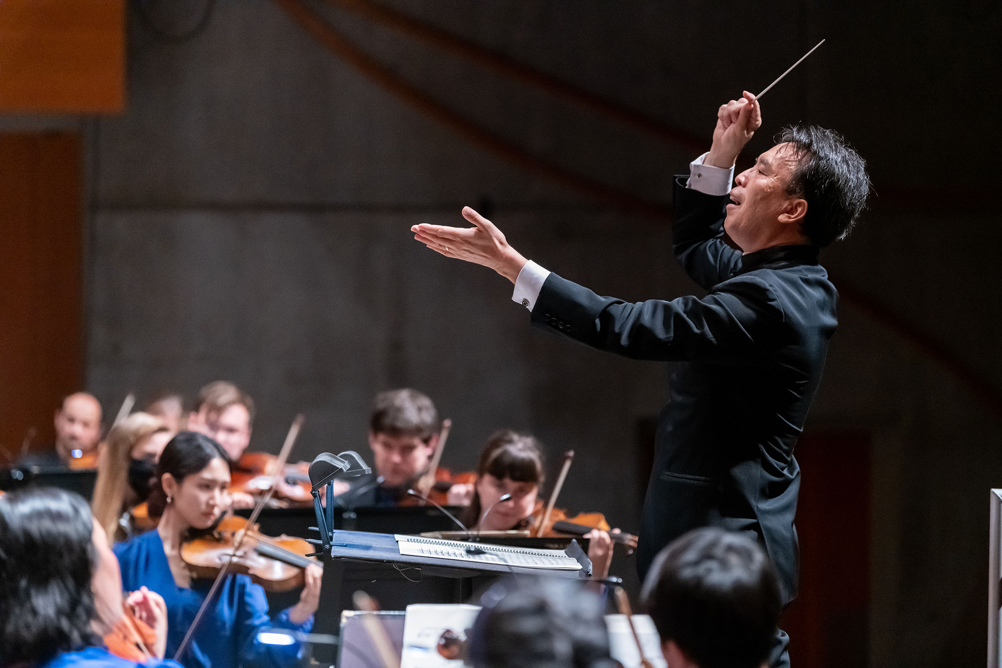 a man conducts an orchestra