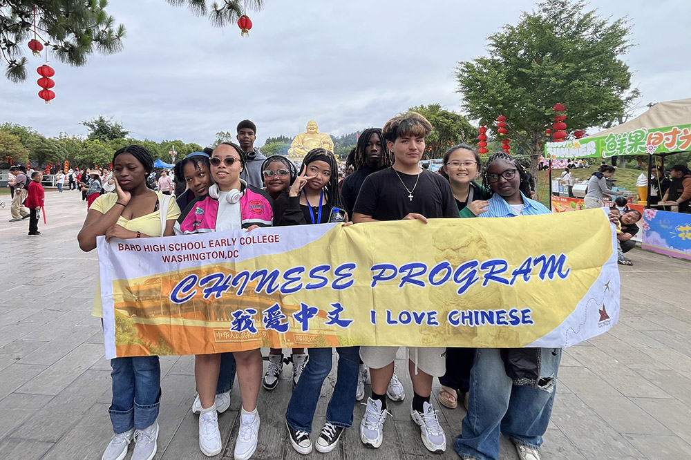 a group of students hold up a banner&nbsp;