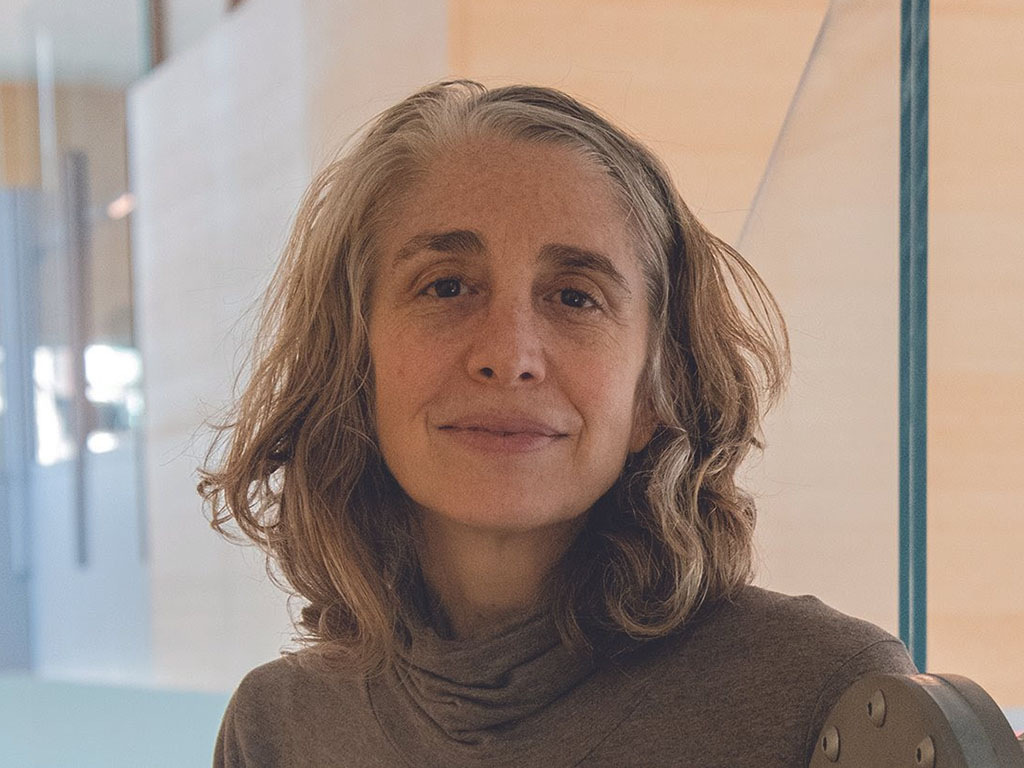 a woman smiles at the camera