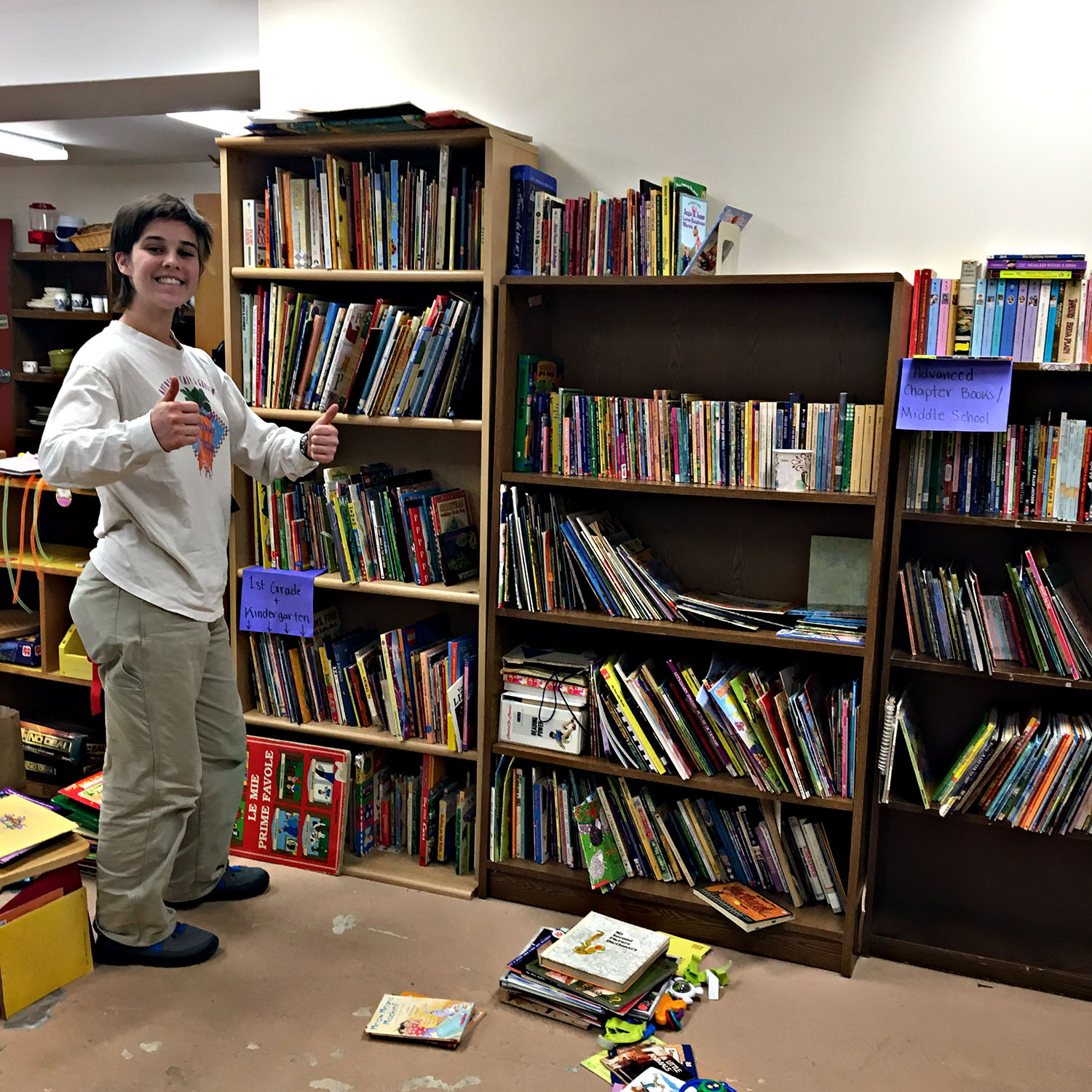 A Bard student volunteer organizes the books in the community closet at the Red Hook Community Center. January 21, 2019.