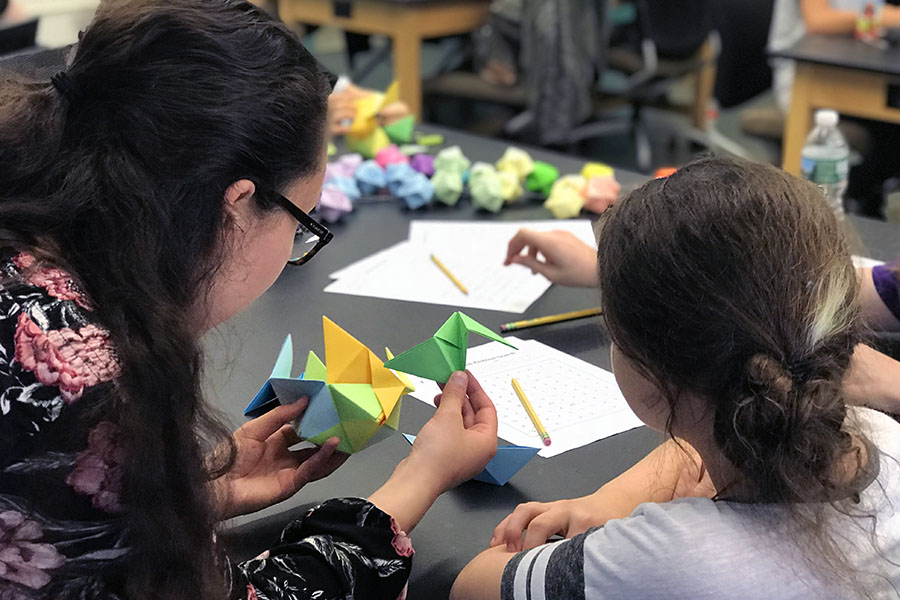 The Girls Math Club, led by Bard students, works on origami designs in the Reem-Kayden&nbsp;Center on Bard&#39;s campus. Photo by Bari Bossis &rsquo;19.