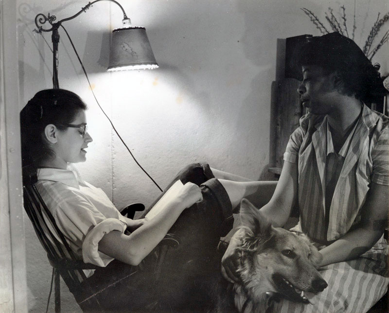 Cynthia Maris Gross &rsquo;54 reads to Emerald McKenzie &rsquo;52, 1952. McKenzie is seen here with her seeing-eye dog, Karen. Gross acted as McKenzie&rsquo;s &ldquo;reader&rdquo; throughout their shared time at Bard. Photograph by David Brook.