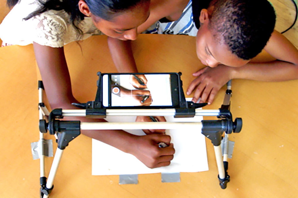 Young filmmakers work on a community-based animation project in Kliptown, South Africa. Photo courtesy of&nbsp;Mocke Jansen Van Veuren&#39;s &quot;Stirring the Beehive: Animating Critical Community Pedagogies&quot; project.&nbsp;